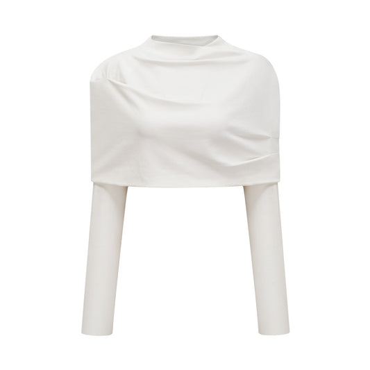 Young woman wearing a white cropped top with ruched detailing on the front and short sleeves