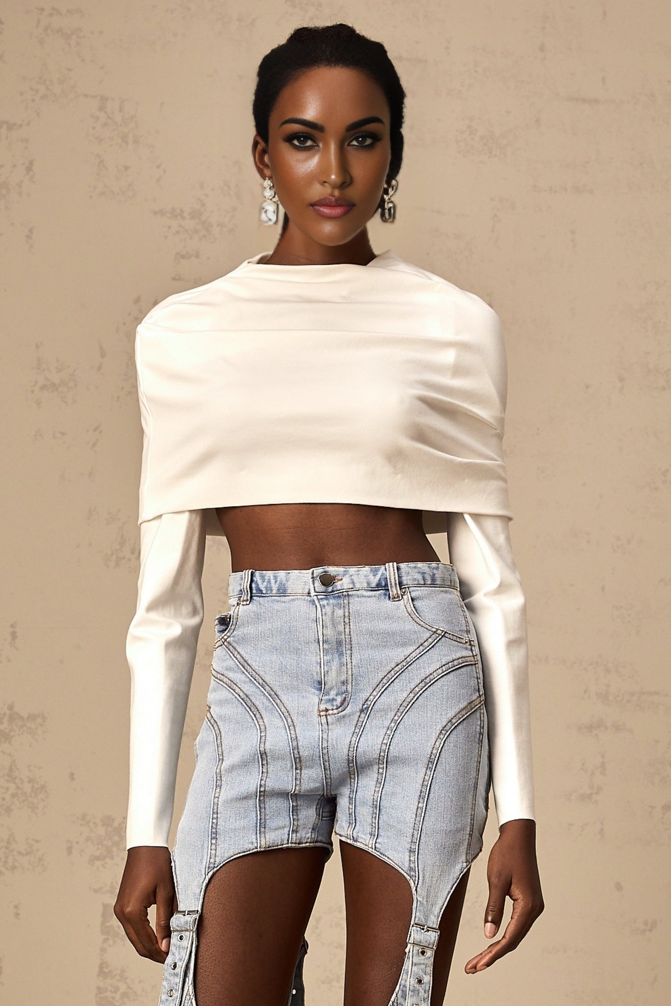 Young woman wearing white sleeveless ruched crop top with gathered fabric detail