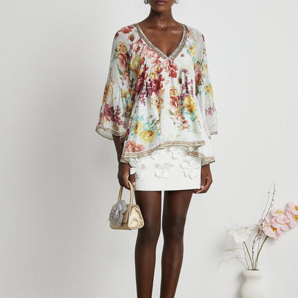 Yvonne White Floral Tulle V-neck Blouse Multicolor Embellished Trim Long Flared Sleeves Pleated Waist Detail