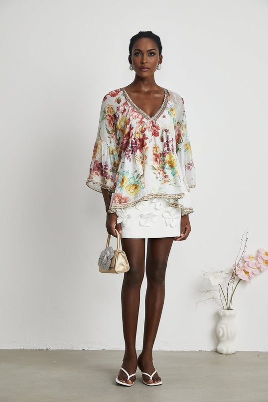 Yvonne White Floral Tulle V-neck Blouse Multicolor Embellished Trim Long Flared Sleeves Pleated Waist Detail