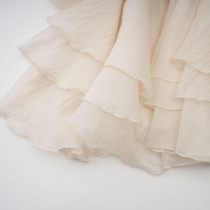Zephyrine floral applique tiered mini dress in neutral colors featuring a layered skirt and decorative flower details